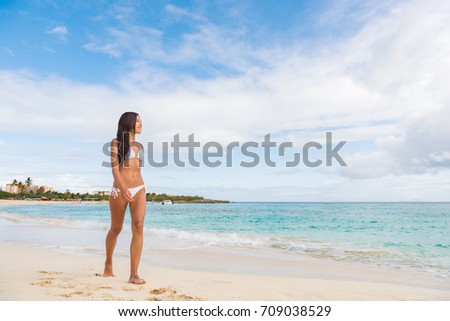 St Maarten beach bikini woman on cruise ship vacation travel walking relaxing in famous touristic destination. Asian girl full length body.