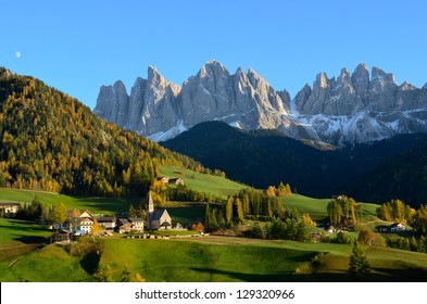 St. Magdalena or Santa Maddalena with its characteristic church in front of the Geisler or Odle Dolomites mountain peaks in the Val di Funes (Villnosstal) in Italy in autumn.