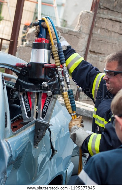 St Marie\
aux Mines - France - 2 October 2018 - closeup of french rescue man\
with pneumatic machine on crashed\
car