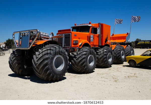 St Maries de la\
Mer, Camargue France - dec 09 2020: Orange monster truck with 10\
big wheels and three big engines is waiting to drive a stunt show\
in the South of France.\
