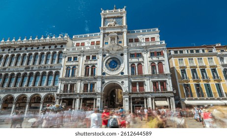 St Mark's Clock tower timelapse hyperlapse on Piazza San Marco, facade, Venice, Italy. Tourists on the square. On the facade of the tower is the astronomical clock, Lion of Saint Mark