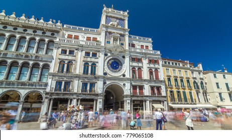 St Mark's Clock tower timelapse hyperlapse on Piazza San Marco, facade, Venice, Italy. Tourists on the square. On the facade of the tower is the astronomical clock, Lion of Saint Mark and Madonna with