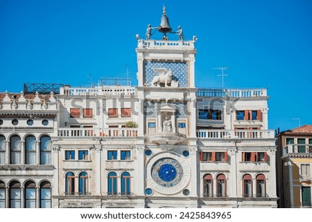 St Mark's Clocktower with clock and statues. View from Piazza San Marco, Venice, Italy