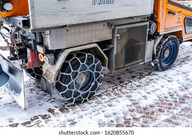 St. Moritz, Switzerland - 22 December, 2019 -Back Tires Of A Road Clean Up Truck Wrap In Winter Chain For Safety In St. Moritz, Switzerland On December 22, 2019