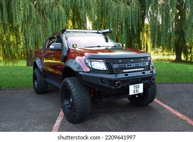 ST NEOTS, CAMBRIDGESHIRE, ENGLAND - OCTOBER 02, 2022:  Ford Raptor 4wd Option Pickup Truck Isolated In Front Of Trees.