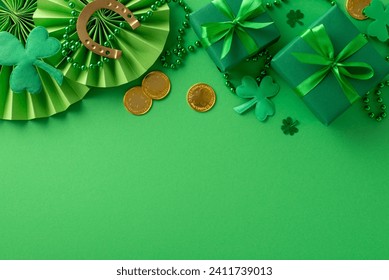 St. Paddy's Day jubilation: Top view of festive display. Gift boxes, horseshoe, gold coins, fans, shamrocks, confetti, beads on a lively green surface. Promote your event - Powered by Shutterstock