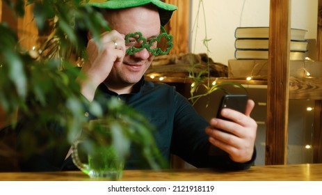 St Patrick Day Concept. Man Celebrating Saint Patricks Day At Home, Having Video Call Using Smartphone.