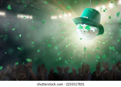 St Patrick disco party in Irish night club. Glowing green clover lantern disco ball in Ireland pub. Shamrock confetti. Group of friends dancing celebrating holiday. Crowd fun celebration. Dance party. - Powered by Shutterstock