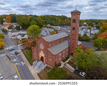 St Patrick Parish church aerial view at 1 Cross Street in fall with foliage in historic village of Whitinsville, town of Northbridge, Massachusetts MA, USA. 