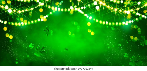 St. Patrick's Day abstract green background decorated with shamrock leaves. Patrick Day pub party celebrating. Abstract Border art design magic backdrop. Widescreen clovers on black with copy space - Powered by Shutterstock