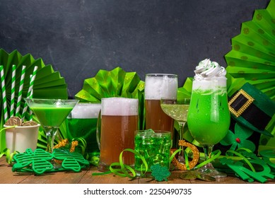 St Patrick's Day bar menu background. Set various golden, green beer glasses, different cocktails and drinks, with St. Patrick's Day party decor and accessories, on dark wooden background - Powered by Shutterstock