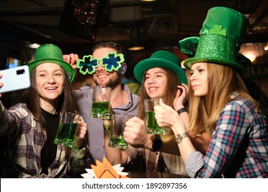 St. Patrick's Day Celebration. The Company Of Young People Celebrate St. Patrick's Day. They Have Fun At The Bar. Irish Holiday, Culture And Tradition.