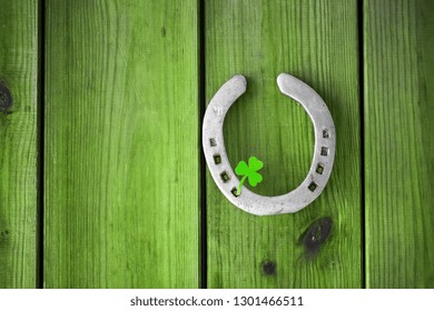 st patrick's day concept - horseshoe with shamrock on green wood boards - Powered by Shutterstock