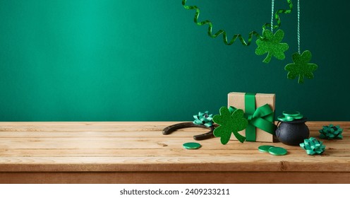 St Patrick's day concept with shamrock and gift box on wooden table over green background. Holiday mock up for design and product display - Powered by Shutterstock