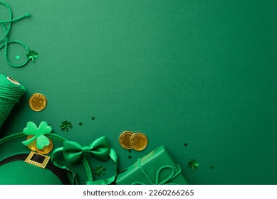 St Patrick's Day concept. Top view photo of leprechaun headwear giftbox with bow spool of twine gold coins bow-tie shamrock and trefoil shaped confetti on isolated green background with copyspace - Powered by Shutterstock