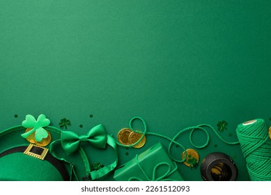 St Patrick's Day concept. Top view photo of leprechaun cap present box spool of twine pot gold coins bow-tie clover and trefoil shaped confetti on isolated green background with copyspace - Powered by Shutterstock