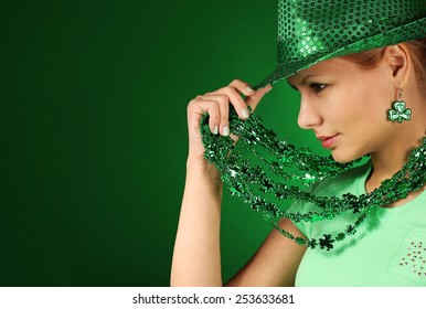 St Patrick's day Girl. Young woman wearing hat over green background