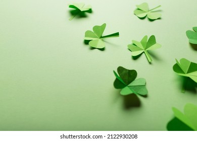 St. Patrick's Day. Green Background With Clover Leaves: Shamrock And Four-leafed. Copy Space. Paper Craft.