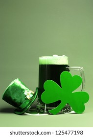 St Patrick's Day Green Beer With Shamrock And Leprechaun Hat Against Green Background. Vertical Portrait Orientation.