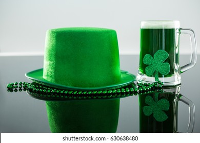 St Patricks Day green beer with shamrock, leprechaun hat and bead on glass surface - Powered by Shutterstock