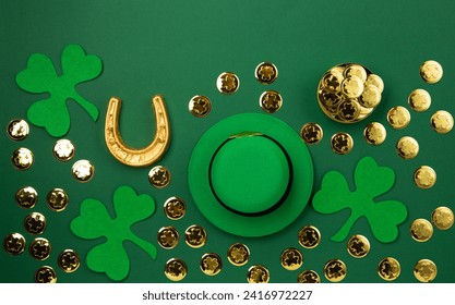 St. Patrick's Day leprechaun hat, gold coins and shamrocks on green background. Irish traditional holiday concept. Top view, copy space. - Powered by Shutterstock