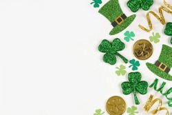 St Patricks Day Side Border Of Green Shamrocks, Leprechaun Hats, Gold Coins And Ribbon. Above View Over A White Background With Copy Space.