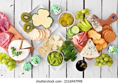 St Patricks Day theme charcuterie table scene against a white wood background. Collection of cheese, meat, fruit and vegetable appetizers. Top down view. - Powered by Shutterstock