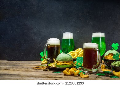St Patrick`s holiday party invitation, bar menu background. Irish St Patrick`s day beer, ale glasses, snacks, appetizer, green burger, wooden bar table with shamrock, clover, coins, leprechaun hat