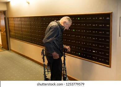 ST PAUL, MINNESOTA - JANUARY 30, 2016: Man Age 94 Opening His Mail Box At Senior Living Facility. 