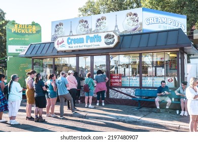 St. Paul, Minnesota - September 3, 2022: People Line Up To Purchase Fresh Cream Puffs At A Booth At The Minnesota State Fair