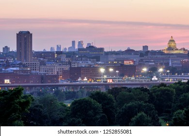 ST. PAUL, MINNESOTA - SUMMER 2017 - A Telephoto Shot Compressing St. Paul And The Capitol Against The Distant Minneapolis Skyline On A Beautiful Summer Twilight