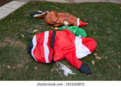 ST PAUL, MINNESOTA USA - DECEMBER 06, 2020: Santa Claus And Other Deflated Christmas Decorations In The Front Yard Of A Home.