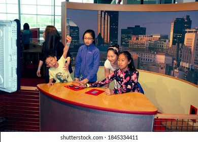 ST PAUL, MINNESOTA / USA - JUNE 10, 2018: Asian American Youths Being Televised At The News Desk In The Science Museum Of Minnesota. 