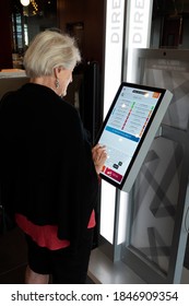 ST PAUL, MINNESOTA / USA - JUNE 06, 2018: Senior Citizen Woman Electronically Selecting A Movie At The AMC Theater In The Mall Of America. 