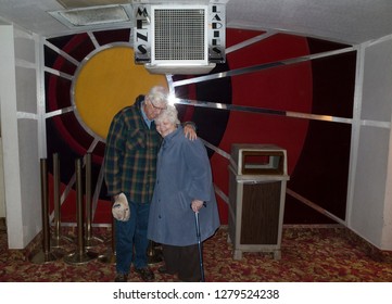 ST PAUL, MINNESOTA USA - MARCH 08, 2016: Loving Senior Couple Photographed Inside An Art Deco Movie Theater Lobby. 