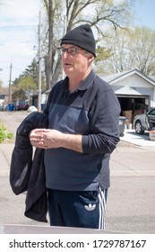 ST PAUL, MINNESOTA / USA - MAY 01, 2020: Friendly Irish Immigrant Out Exercising In The Neighborhood Practicing Social Distancing. 