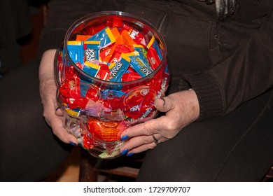 ST PAUL, MINNESOTA / USA - OCTOBER 31, 2019: Woman Holding A Halloween Bowl Of Wrapped Candy. 