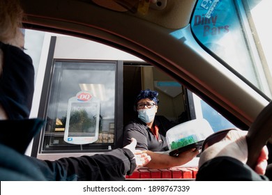 ST PAUL, MINNESOTA USA - OCTOBER 02, 2020: An Ice Cream Birthday Cake Is Being Pickup At Dairy Queen By Masked People During The Covid Pandemic. 