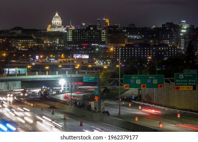 ST. PAUL, MN - OCTOBER 2017 - A Telephoto Night Shot Of The Minnesota State Capitol Building Compressed With The Distant Minneapolis Skyline As Highway Traffic Blurs Past