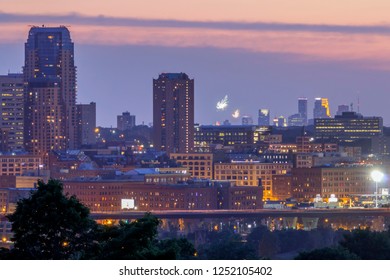 ST. PAUL, MN - SUMMER 2017 - A Telephoto Shot Compressing The Distant Minneapolis Skyline And Fireworks With Part Of The St. Paul Skyline During Twilight