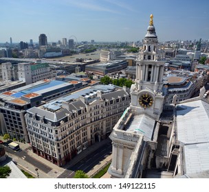 St Paul's Cathedral Clock Tower and  aerial panorama of the city of London. In the background is the Thames River.
