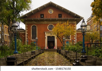 St Pauls Church In Covent Garden On A Rainy Day With Autumn Leaves On The Floor And Christmas Decorations In The Doorway. London - 2nd November 2019