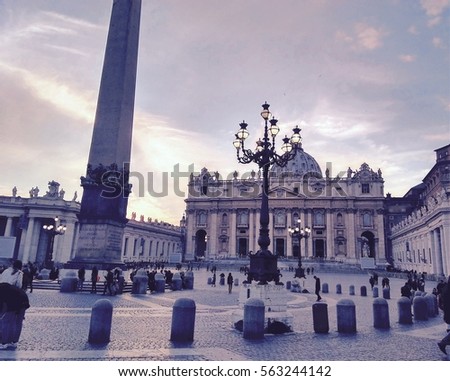 St. Peter Basilica retro photo from square perspective with obelisk, sky with clouds, tourists and vintage lamp post, Vatican Rome