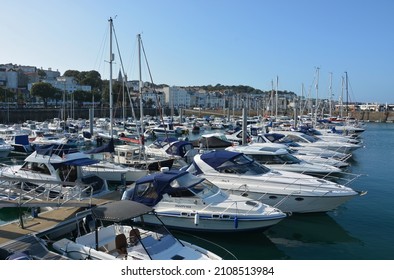 ST PETER PORT, UNITED KINGDOM - Aug 10, 2019: A view of luxury yachts and boats moored in St  Peter Port harbour on the island of Guernsey, Channel Islands, under a blue sky on a summer's day 