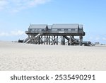 St. Peter-Ording, coast on the Wadden Sea with beach and pile dwellings of the beach pavilion, Schleswig-Holstein, Germany