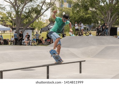 St. Petersburg, Florida / USA - June 1, 2019: Young Man Doing A Rail Slide With His Skateboard At The St.Petersburg Regional Skatepark