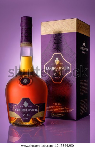 St. Petersburg, Leningrad region Russia -\
November 9, 2017 a bottle of cognac and a box of Courvoisier on a\
purple background