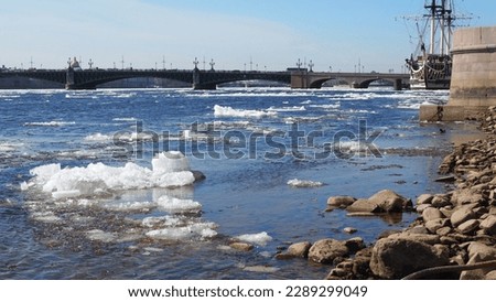 St Petersburg, Russia, 04-14-2023: ice drift on the Neva river, the water level in the river fell by more than a meter due to the northeast wind, sailing ship near embankment