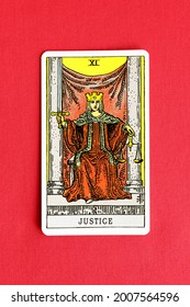 St. Petersburg, Russia, 12 July 2021: Illustrative editorial. Tarot card on red fabric background. Major Arcana XI Justice.
