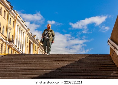 St. Petersburg, Russia, August 13, 2022. Subway Station Entrance. Elderly Woman Walking Up The Stairs
